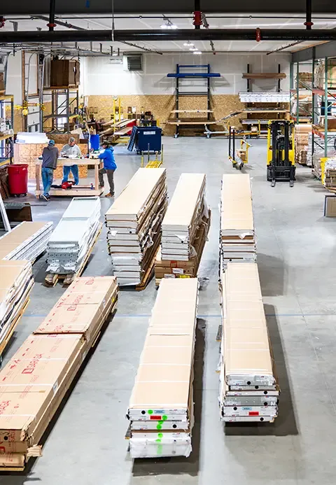 Western States Garage Door Supply Inc. spacious warehouse with high shelves stacked with boxes and materials.