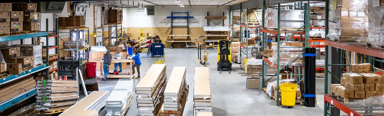 Western States Garage Door Supply Inc. spacious warehouse with high shelves stacked with boxes and materials.